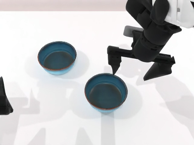 Robot gripper above two blue bowls