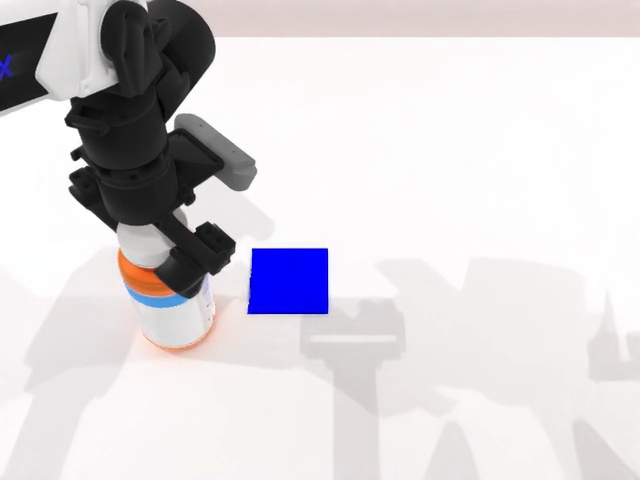 Robot gripper near a blue block