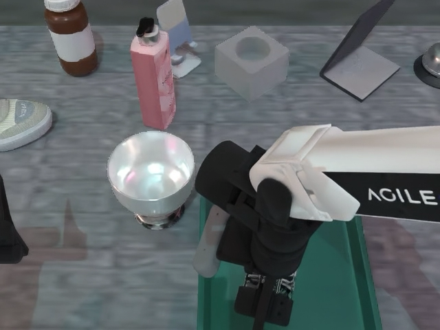 Robot arm interacting with objects on a tabletop